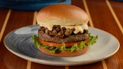The Bayou Amber Ale Burger featuring a burger topped with prime rib and cheese between 2 buns