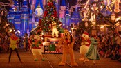 Pluto, Donald, Daisy, Peter Pan and Wendy walk down Main Street U S A in front of Mickey Mouse on a parade float