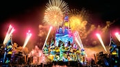 Halloween images are projected on to Cinderella Castle as fireworks explode in the sky