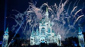 Animated skeletons are projected on to Cinderella Castle as firework smoke trails line the sky