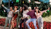 3 young men and 3 young women posing for a photo by a giant Christmas tree in EPCOT