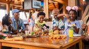 A large family dining at Geyser Point Bar & Grill at Disney's Wilderness Lodge