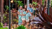 A multigenerational family posing for a Signature Portrait at Disney’s Polynesian Village Resort
