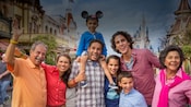A multi generational family posing for a family together on Main Street, U.S.A. at Magic Kingdom park