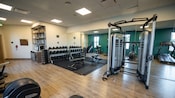 A gym containing dumbbells and exercise machines at Disney’s Coronado Springs Resort