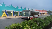 A Disney Transport bus rests near the entrance to Disney’s All Star Music Resort