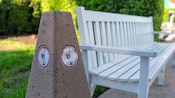A concrete receptacle bears an icon indicating it as a safe place to extinguish and dispose of cigarettes
