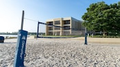 A beach volleyball court set up near a lake at Disney's Contemporary Resort