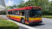 A hotel shuttle bus features a Mickey Mouse design, and a sign on the front saying, ‘Hakuna Matata’