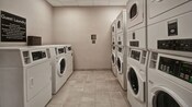 Una lavandería de hotel con varias lavadoras y secadoras