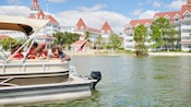 A family on a motorized boat along Seven Seas Lagoon in Walt Disney World Resort