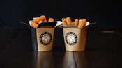 Two containers printed with Big Boi Lumpia Co filled with Filipino spring rolls