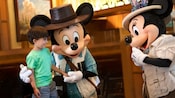 A little boy smiles as he is greeted by Mickey Mouse and Minnie Mouse at Disneys Grand Californian Hotel and Spa.