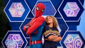 A young Guest posing for a picture with Spider Man in Disney California Adventure Park