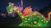 At 16 feet tall and more than 10 feet wide, Elliot the dragon is lit up at night during the Main Street Electrical Parade.