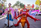 Mulan, Mushu and Cast Members taking part in Mulan's Lunar New Year Procession at Disney California Adventure Park