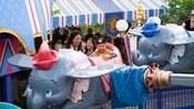 Mom and kids riding Dumbo in Disneyland