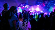 Guests taking in dazzling lights and projections during the night at the Disneyland Resort.