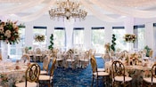 The Sleeping Beauty Pavilion at the Disneyland Hotel featuring tables, chairs, floral arrangements and a chandelier