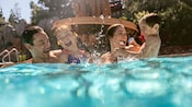 A family making a splash in a Disneyland Resort hotel pool.