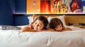 Two children relax in their hotel room at the Disneyland Resort