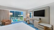 A hotel room with a queen bed and window overlooking the pool at the Hilton Anaheim