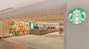 The entrance to Starbucks at the Hilton Anaheim with an illuminated logo on the wall
