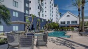 Outdoor swimming pool with lounge chairs and tables with seating at Homewood Suites by Hilton Anaheim Maingate Area