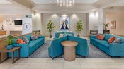 Un lobby con un cartel de los Hoteles Good Neighbor del Disneyland Resort y varios sofás en Sonesta ES Suites