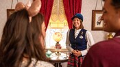 A V I P Tour Guide with a group of Guests inside of Walt Disney’s personal quarters in Disneyland Park