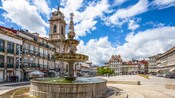 A large decorative fountain in the middle of an old town