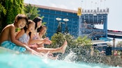 A family making a splash in the pool at the Disneyland Hotel. A family making a splash in the pool at the Disneyland Hotel.