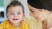 A woman smiles at a boy toddler