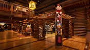 A totem pole made of Disney characters at the entrance to the Mercantile shop in the Resort lobby