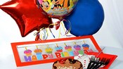 A balloon bouquet with a banner that reads ‘Happy Birthday’