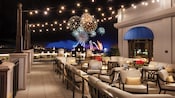 Nighttime fireworks views from the rooftop deck at Topolino's Terrace – Flavors of the Riviera restaurant