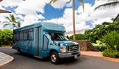 An Aulani shuttle bus parked on a driveway
