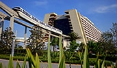 A monorail train exiting from within Disney's Contemporary Resort
