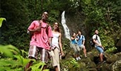 Guests hike by a waterfall