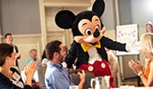 Mickey Mouse meeting attendees in a conference room
