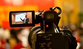 A video camera recording a presentation