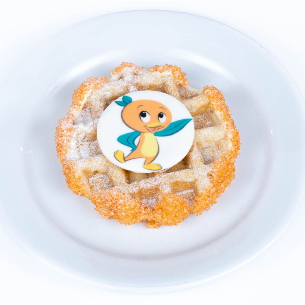 A waffle topped with an Orange Bird candy piece
