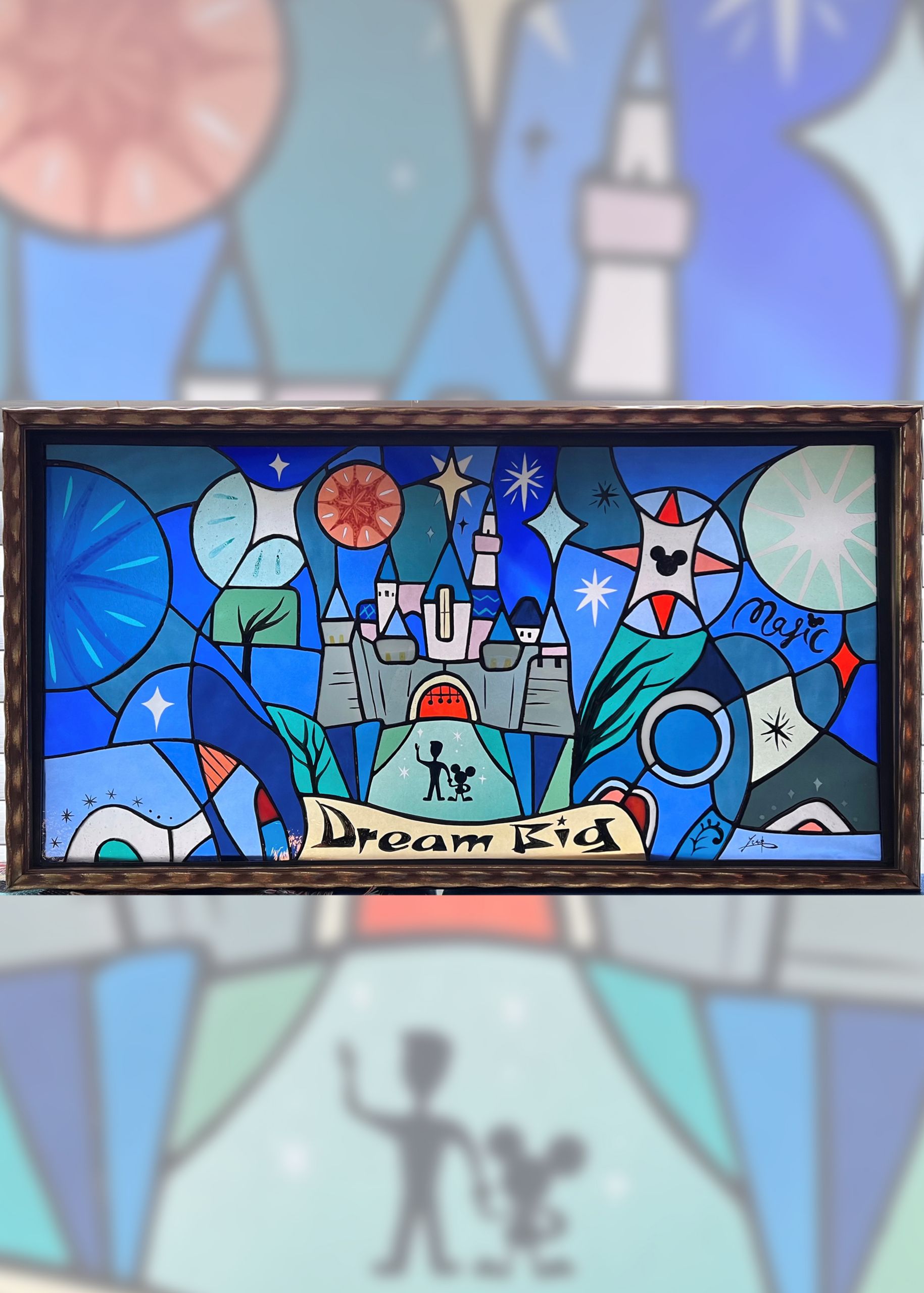 A piece of art depicts silhouettes of Walt Disney and Mickey Mouse in front of Sleeping Beauty Castle