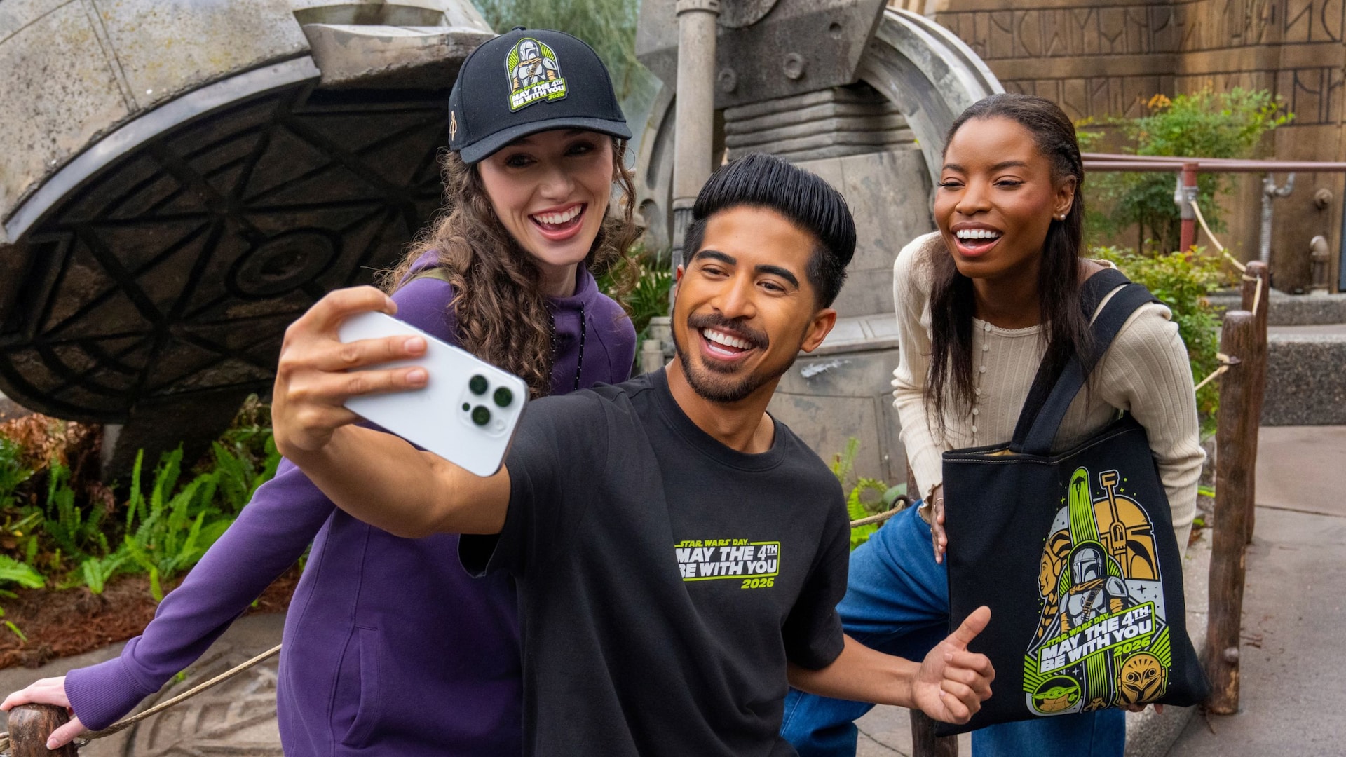 Three Guests in Star Wars merchandise while taking a selfie near Star Tours The Adventures Continue at Disney's Hollywood Studios theme park