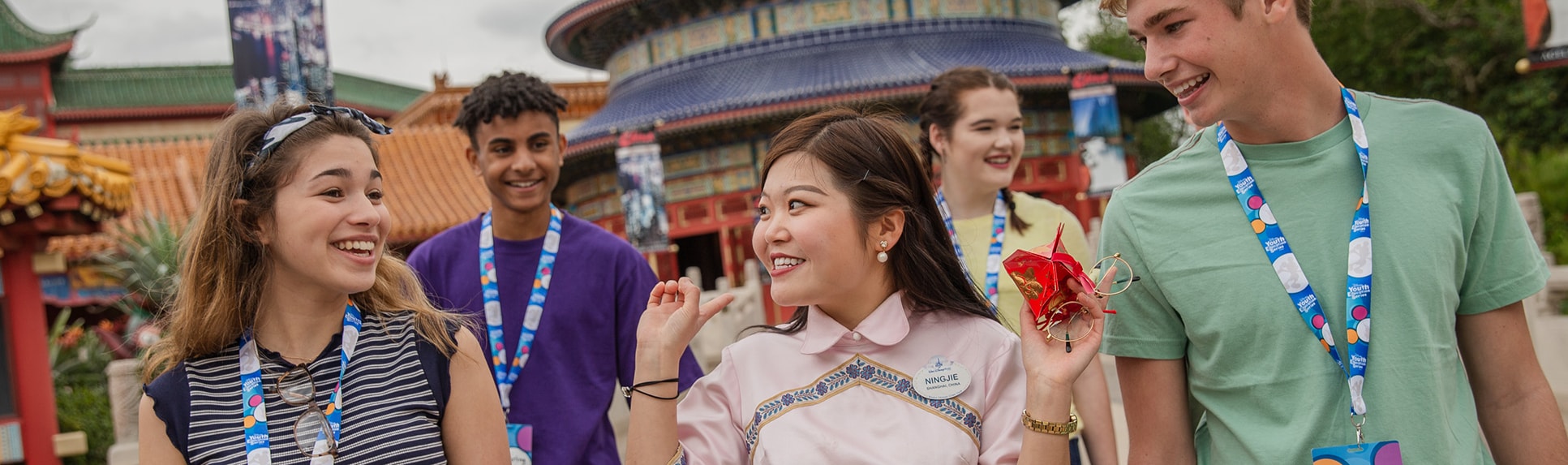 A Cast Member with a group of teenagers in front of the China Pavilion at EPCOT