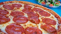 A Mega Pepperoni pizza from Alien Pizza Planet and a garden salad in the background
