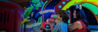 A mother and son experiencing Alien Swirling Saucers in Toy Story Land at Walt Disney World Resort