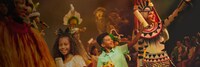 Guests dancing in a parade line with costumed performers at Tusker House in Disney’s Animal Kingdom theme park