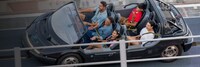 A family experiencing Test Track in an open air vehicle at Epcot  
