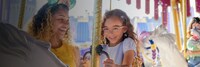 A mother and daughter riding Prince Charming Regal Carrousel at Walt Disney World Resort